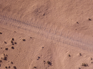 Aerial view of a desert landscape on the island of Lanzarote, Canary Islands, Spain. Road that crosses a desert.  Dirt road. Formed by the crossing of off-road vehicles