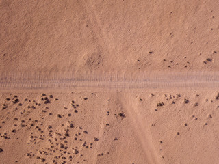 Aerial view of a desert landscape on the island of Lanzarote, Canary Islands, Spain. Road that crosses a desert.  Dirt road. Formed by the crossing of off-road vehicles