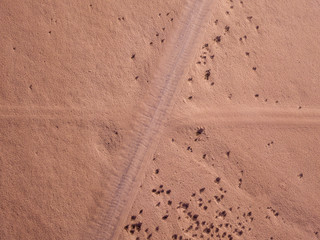 Aerial view of a desert landscape on the island of Lanzarote, Canary Islands, Spain. Road that crosses a desert.  Dirt road. Formed by the crossing of off-road vehicles