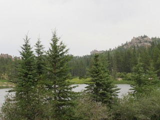 Lush trees surrounding beautiful Sylvan Lake, Custer State Park, South Dakota.  