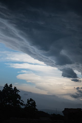 Dramatic morning sky with dark and white clouds, beautiful vertical cloudscape suitable for book cover, ominous atmosphere