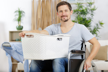 disabled man in wheelchair doing laundry