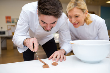 chef cook pouring chocolate during production process