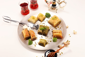 Middle eastern or arabic dishes. Turkish Dessert Baklava with pistachio on dishes