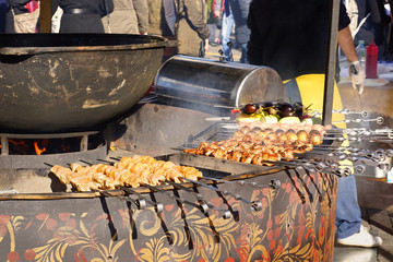Barbecue. Cooking street food. Meat is fried over an open fire. Festival 