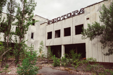 Chernobyl Exclusion Zone, Ukraine. Destroyed abandoned ghost city Pripyat ruins after disaster. Nuclear Power Plant atomic reactor sign. Lost town. Text translation: restaurant.
