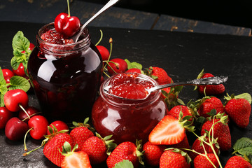 assortment of jams, seasonal berries, mint and fruits. marmalade or confiture