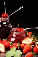 assortment of jams, seasonal berries, mint and fruits. marmalade or confiture