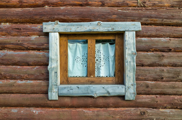 Obraz na płótnie Canvas View of the window of a wooden hut