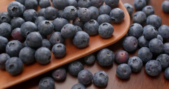 Heap of blueberry on wooden plate