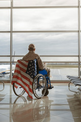 Back view of military man sitting in wheelchair