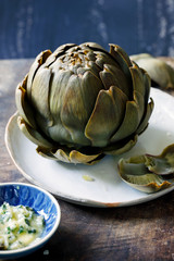 Whole steamed globe artichoke with garlic butter dip