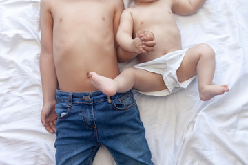 Happy childhood concept. Happy brothers portrait. 6 years and 6 months old boys having fun. Two little kids smiling having good time. Cute little brothers lying and playing together