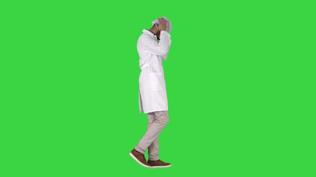 Arabic doctor walking and putting medical cap on on a Green Screen, Chroma Key.