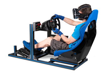 gamer in blue tshirt with VR virtual reality glasses training on simracing aluminum simulator rig...