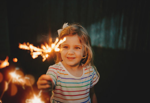 Little girl doing firework sparkler