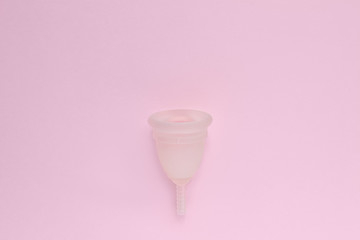 Menstrual cup on pink background. Alternative feminine hygiene product during the period. Women health concept. Copy space