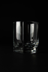 empty glass for whiskey on a black background
