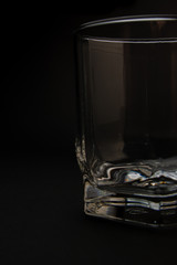 empty glass for whiskey on a black background