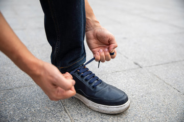 Hands tying shoe laces