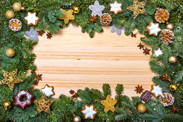 Fototapeta na wymiar Christmas frame. Christmas card. New Year`s greetings. Frame with branches of a Christmas tree decorated with balls, toys and cookies