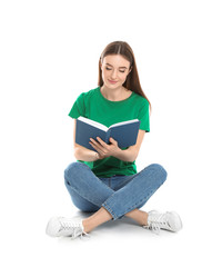 Young woman reading book on white background