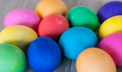 Close up of 12 Easter eggs on light wood background