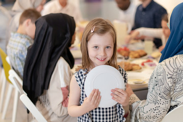 cute little girl enjoying iftar dinner with family