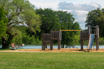 playground with bench and grill at lake