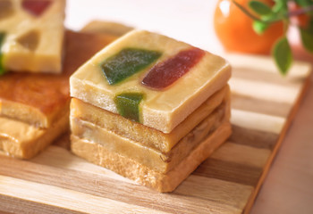 The pyramid of the turron with marmalade on a wooden tray. Selective focus. Blurred background....