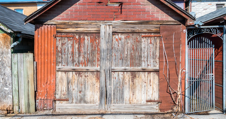 Old rustic and weathered garage and wrought iron gateway