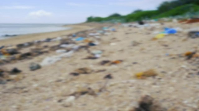 Trash, plastic, garbage, bottle... environmental pollution on the beach. Royalty high-quality free stock blurry footage of trash, plastic bottle on the beach. Waste that polluted the ocean environment
