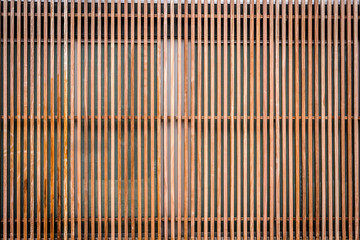Wall of thin wooden slats, vertical parallel plates. Empty background