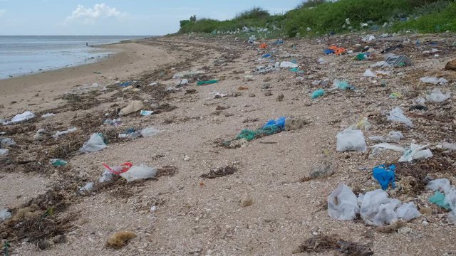 Trash, plastic, garbage, bottle... environmental pollution on the beach. Royalty high-quality free stock photo footage of trash, plastic bottle on the beach. Waste that polluted the ocean environment