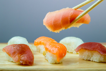 Fresh salmon sushi , salmon maki roll Japanese food restaurant, salmon sushi on plate. Sushi platter with a mixed variety of the Japanese delicacy at a buffet spread table.