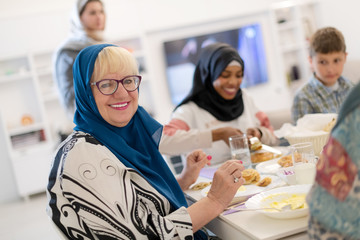 Fototapeta premium modern multiethnic muslim family having a Ramadan feast
