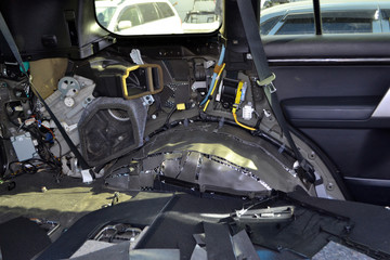 Tuning the car in a SUV body with three layers of noise insulation on the floor. Sound and vibration isolation using soft and pimply material with a car breakdown.