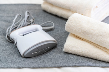 .Portable iron and towels placed on the bed