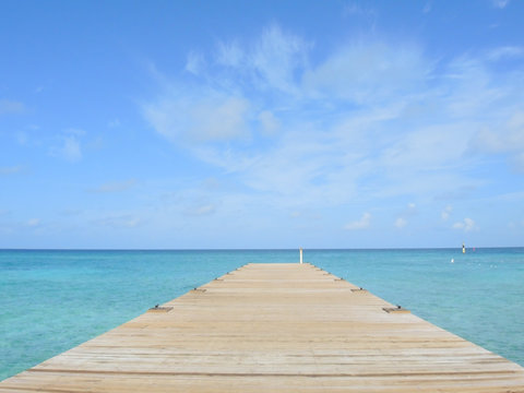 Landscape of a pier leading out to the ocean  