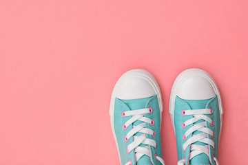 A pair of turquoise sneakers on a pink background. Color trend 2019. Sports style. Flat lay.