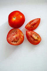 Tomatoes on a white background lay flat on the concept of food. 