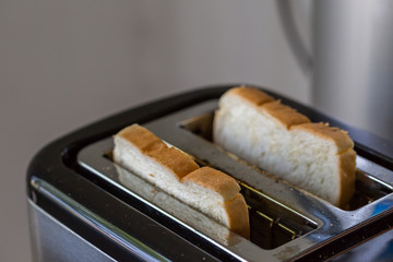 Toaster and two hot toasts ready to eat