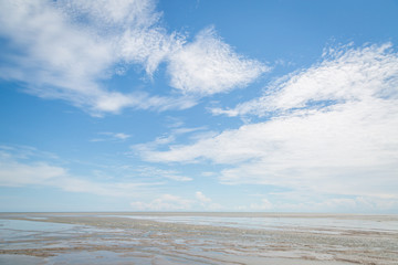 Fototapeta na wymiar Sand blue sky and clouds background