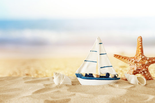 vintage wooden boat over beach sand and sea landscape background