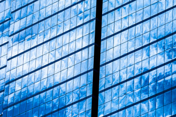 Fototapeta na wymiar Blue glass windows of office building