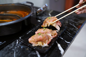 Wagyu beef nigiri sushi set - A plate of steamed rice wrapped by slice of grilled Okinawa beef and topped with chopped spring onion on wooden table, Traditional Japanese Food.