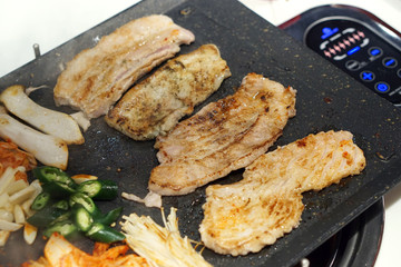 Korean grilled pork belly BBQ (Samgyeopsal Gui) - The popular Korean barbecue dish, served with fresh lettuce and a spicy dipping sauce.
