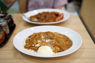 Japanese curry rice with thinly sliced boiled pork and soft boiled egg.