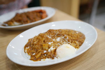 Japanese curry rice with thinly sliced boiled pork and soft boiled egg.