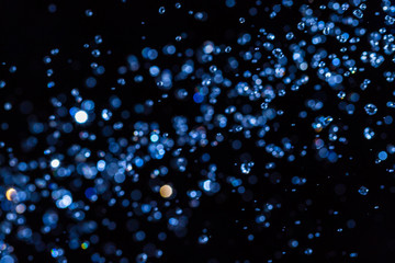 Fototapeta premium Abstract blue bokeh on black